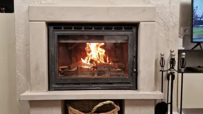 a fireplace with a fire inside of it at Luxe Apartment Grand Monastery in Pamporovo in Pamporovo