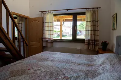 a bedroom with a bed and a window at Walnut Cottage 1 in Deredzhik-Kʼoy