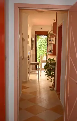 a hallway leading into a kitchen with a plant at Villa Magicland in Sofia