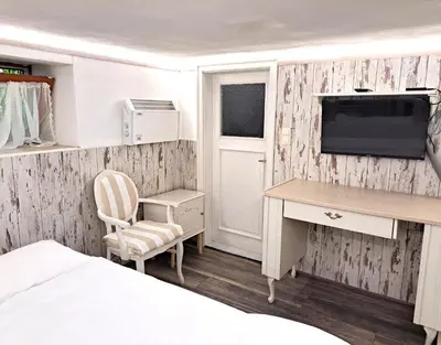 a bedroom with a desk and a tv on a wall at Villa Magicland in Sofia