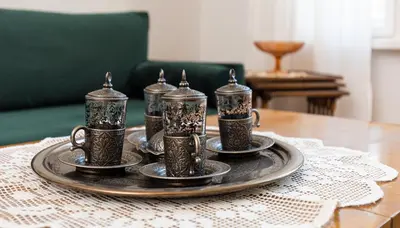 a tray with four coffee cups and saucers on a table at The Old Town Vintage 2-Bedroom Jewel by Flat Mаnager in Plovdiv