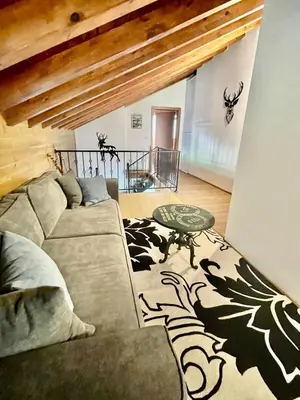 a living room with a couch and a table at Pirin Golf Penthouse Iliyana in Bansko