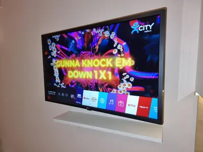 a flat screen tv on a white wall at Borovets Ski&Spa Studio - Semiramida Garden A16 in Borovets