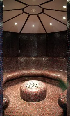 a room with a bath tub with a table and chairs at Borovets Ski&Spa Studio - Semiramida Garden A16 in Borovets