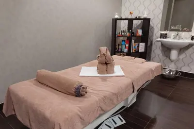 a bed with a stuffed animal sitting on top of it at Borovets Ski&Spa Studio - Semiramida Garden A16 in Borovets
