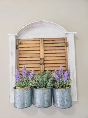 three metal pots with purple flowers in front of a wooden door at Lovely Borovets Apartment in Borovets