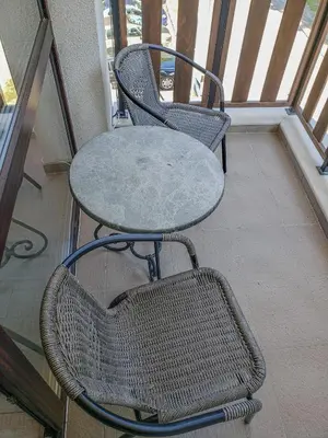 a table and two chairs sitting on a balcony at Lovely Borovets Apartment in Borovets