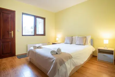 a bedroom with a large bed with towels on it at Вили Тихия Кът in Ribarica
