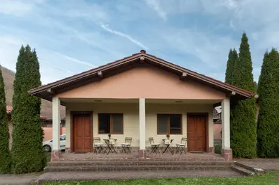 a small house with chairs and a porch at Вили Тихия Кът in Ribarica
