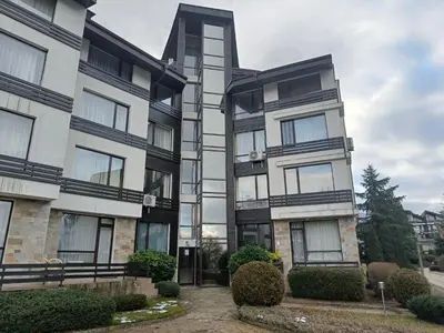 an apartment building with black and white windows at Aspen Golf Resort Studio I205 in Bansko