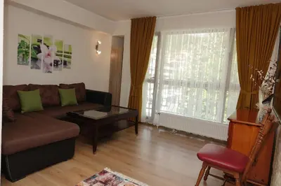 a living room with a couch and a table at Стаи за гости RADEA in Devin