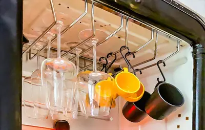 a bunch of utensils hanging from a rack at Sofia Downtown Boutique Apartment in Sofia