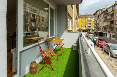 a balcony with two chairs and a table on a balcony at Sofia Downtown Boutique Apartment in Sofia