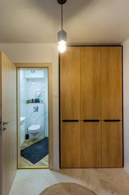 a bathroom with a wooden closet and a toilet at Sofia Downtown Boutique Apartment in Sofia