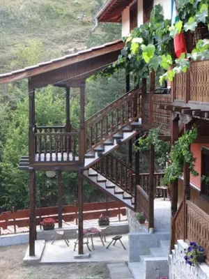 a wooden staircase on the side of a building at Недкова къща in Koprivshtitsa