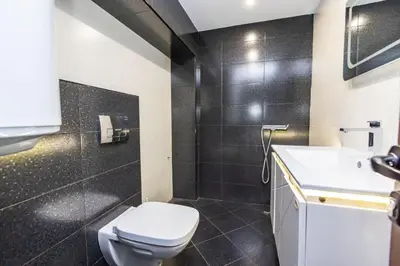 a bathroom with a toilet and a sink at Мезонет Пасажио in Sandanski