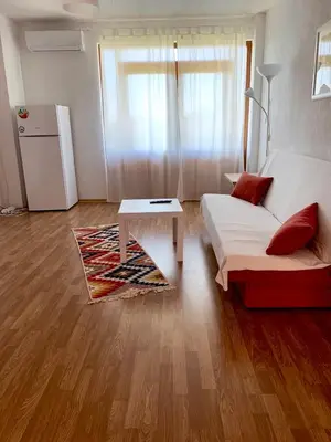 a living room with a white couch and a table at Sunny Home in Sandanski