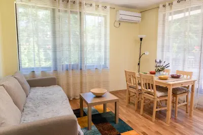 a living room with a couch and a table at Bendida Park in Velingrad