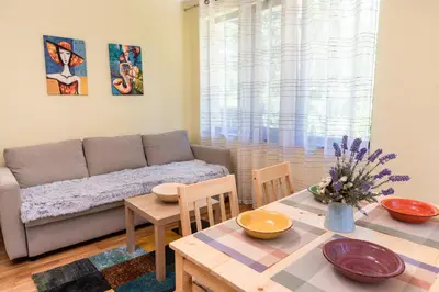 a living room with a couch and a table at Bendida Park in Velingrad