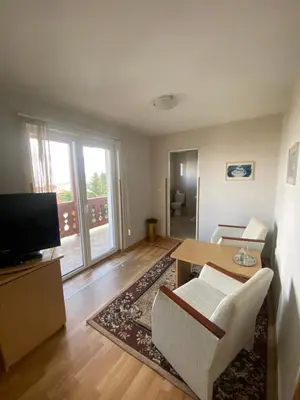 a living room with a couch and a table at Family Hotel Zdravets in Sofia