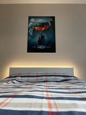 a poster of a movie hanging above a bed at Movie flats in Sofia