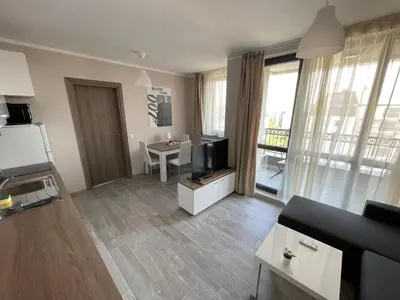 a living room with a couch and a tv and a table at Movie flats in Sofia