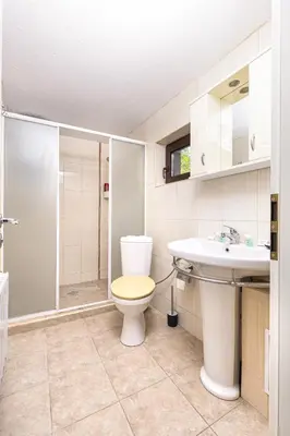 a bathroom with a toilet and a sink and a shower at Peaceful Riverside Studio with private Garden Center Parking in Plovdiv