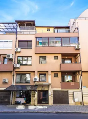 an apartment building with balconies on a street at Peaceful Riverside Studio with private Garden Center Parking in Plovdiv