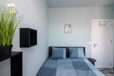 a bedroom with a bed with blue pillows at Mountain View Apartment 1 + Parking in Sofia