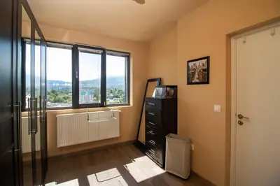a room with a window and a black dresser at Vitosha View Apartment with Parking in Sofia