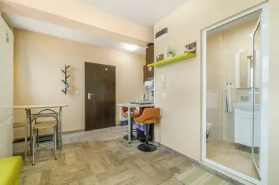 a small room with a table and a bathroom at Vitosha View Apartment with Parking in Sofia