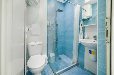a bathroom with a toilet and a shower and a sink at City View Apartment + Parking in Sofia