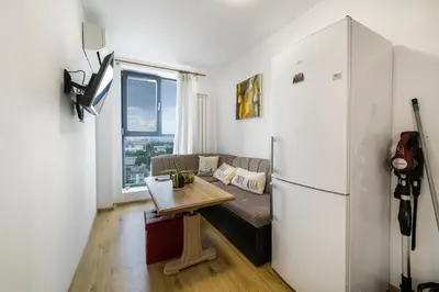 a living room with a couch and a refrigerator at City View Apartment + Parking in Sofia