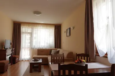 a living room with a couch and a table at GO GO Holiday in Borovets