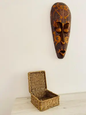 a chair and a mask hanging on a wall at City Center 2-bedroom cosy apartment in Plovdiv