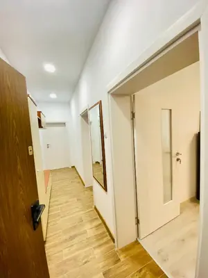 an empty hallway with a door and a mirror at City Center 2-bedroom cosy apartment in Plovdiv