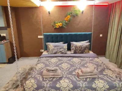 a bedroom with a swing bed with two towels on it at Кокиче 3 in Sofia