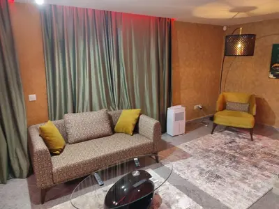 a living room with a couch and a chair at Кокиче 3 in Sofia