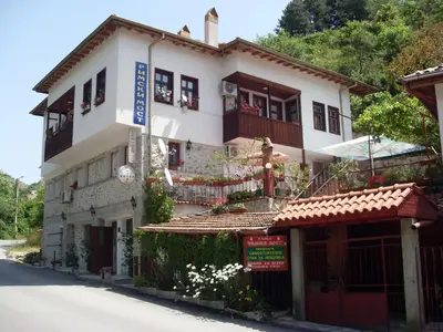 a large white building on the side of a street at Guest House Rimski Most in Melnik
