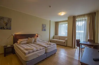 a bedroom with a bed and a couch and a table at Euphoria Club and Resort Rental in Bŭrduche