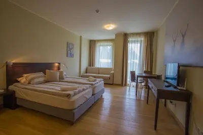 a bedroom with a bed and a desk and a television at Euphoria Club and Resort Rental in Bŭrduche