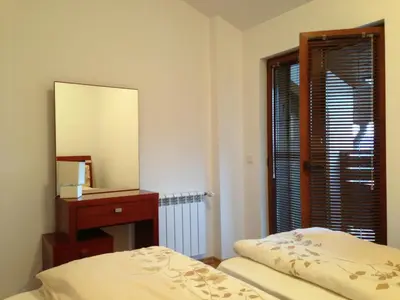 a bedroom with a mirror and a bed and a dresser at Mountain View Resort - Apartment B45 in Bansko