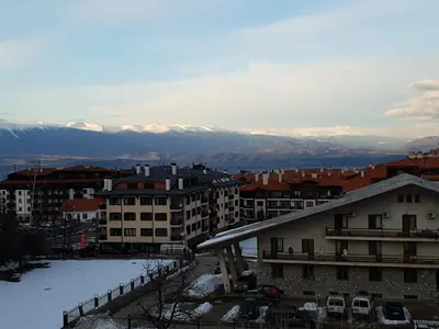 a view of a city with snow covered buildings and mountains at Mountain View Resort - Apartment B45 in Bansko