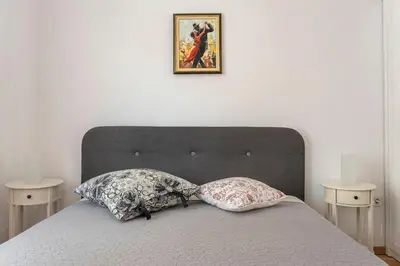 a bed with two pillows and a picture on the wall at 