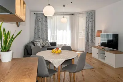 a living room with a table and chairs and a television at 