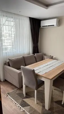a living room with a table and a couch at ORION APARTMENTS in Chepelare