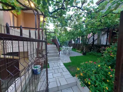a garden with stairs and a yard with flowers at White grapes apartment in Petrich