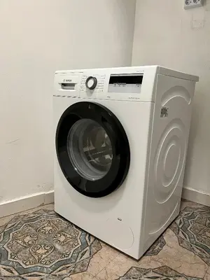 a washing machine is sitting in a room at The rainbow 4 in Sofia