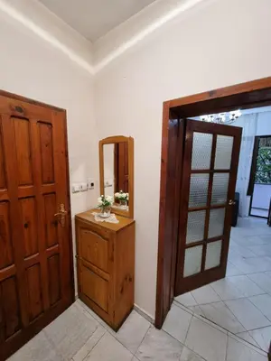 a bathroom with a mirror and a wooden door at Tsar Simeon, 2 bedroom, living room and fireplace in Sofia