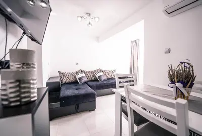 a living room with a couch and a table at The moon in Sandanski